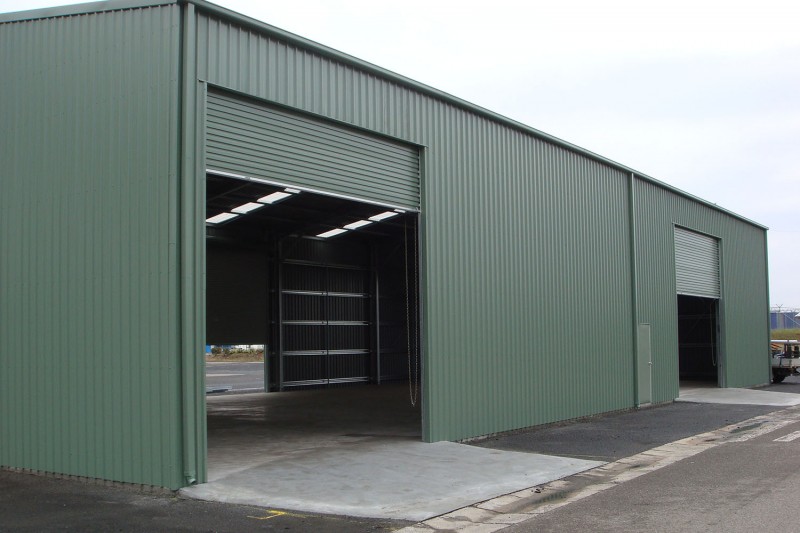 Commercial factory shed side vie with two industrial roller doors