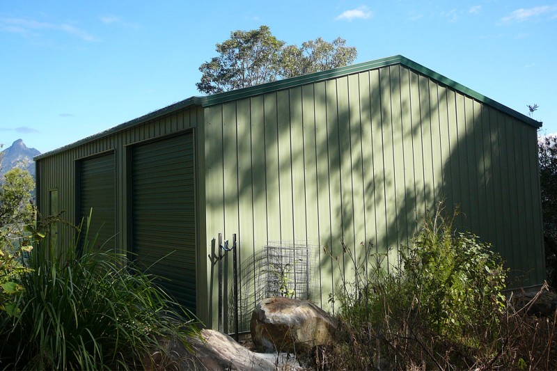 Green colorbond double garage with twin doors on length
